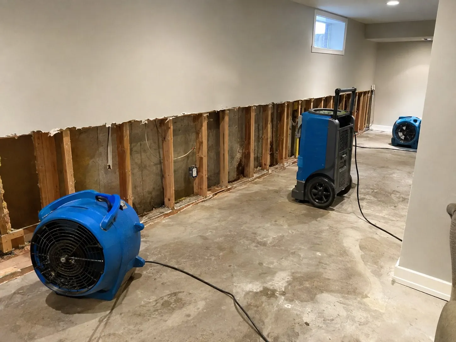 Lower drywall removed with drying equipment running