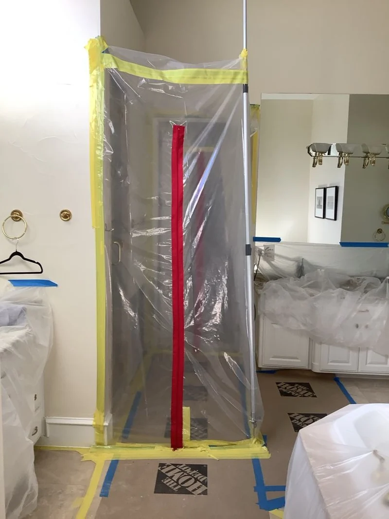 Zippered containment and protected bathroom finishes in the documented Southlake remediation project